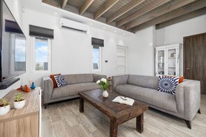 Unwind in style in this cozy living room, featuring a plush sofa perfect for relaxing after a long day.