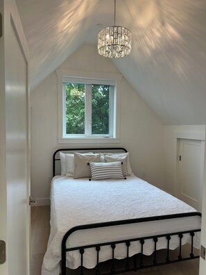 Bedroom with queen bed. His and closet space and extra storage for luggage.