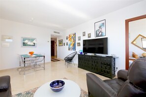 Another view of the modern lounge with dining area for four guests