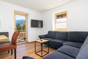 Ferienwohnung Berghupferl, Vier-Raum-Wohnung-Couchbereich mit Balkonzugang und Bergblick