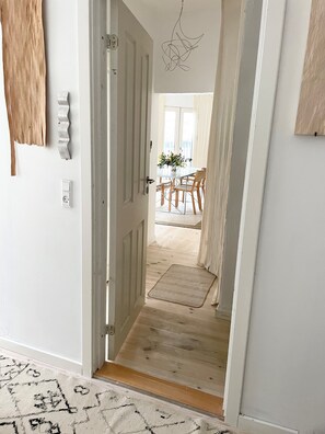 view from the large bedroom towards the dining-living area