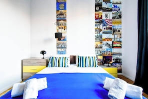 Experience ultimate relaxation in this bright and spacious bedroom with artistic decor. Ideal for couples or solo travelers. Reserve today!