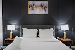 Stylish bedroom with dark accent wall and contemporary decor
