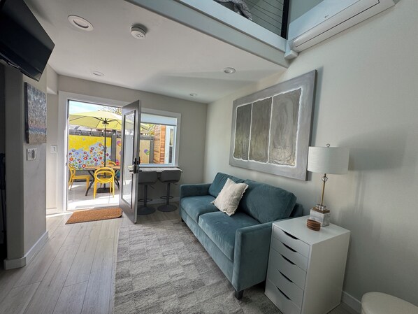 Here’s the living room, with the private-oasis, art-filled yard at the back.