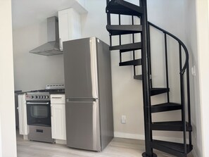 Spiral stairs lead to the sleeping loft.
