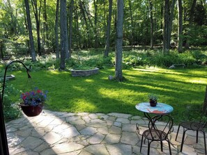 2nd unfenced patio with natural stone. Table & 2 bistro chairs not to be moved.