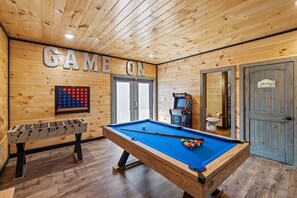 Game room includes arcade, pool table, foosball, and movie area.