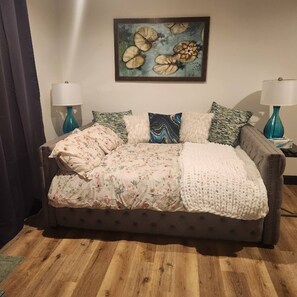 Comfortable bed with a double/full mattress and lots of pillows