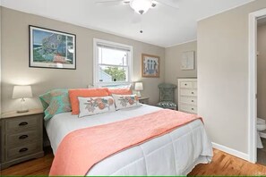 Cozy queen bed, soft linens, and beachy touches — perfect for a peaceful night's sleep after a day in the sun.