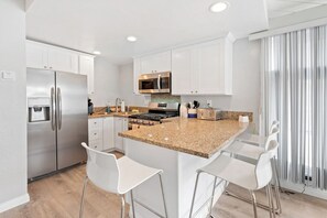 Kitchen is located right as you enter the home.  It has all kitchen essentials needed for a comfortable stay. 
Keurig Coffee machine and coffee provided. 