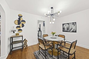 Dining Area: A cozy dining area with a sleek marble table and industrial-style chairs.
