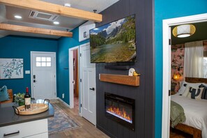 A 55" smart TV (with a crazy long extension arm), and electric fireplace for a great night in streaming your faves.