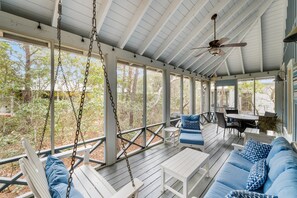 Screened in porch with swing and enough seating for everyone in your family