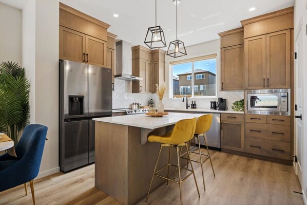 Experience The Heart Of The Home In Our Warm Kitchen Featuring A Cozy Island And Spacious Fridge