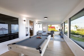 Family Game room with pool table, entertainment center and ocean views.