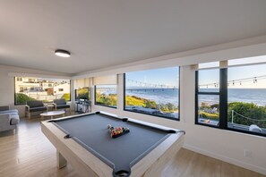 game room with pool table and view of the ocean
