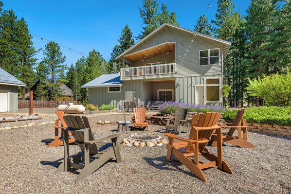 Backyard with outdoor chairs, string lights perfect for family gathering