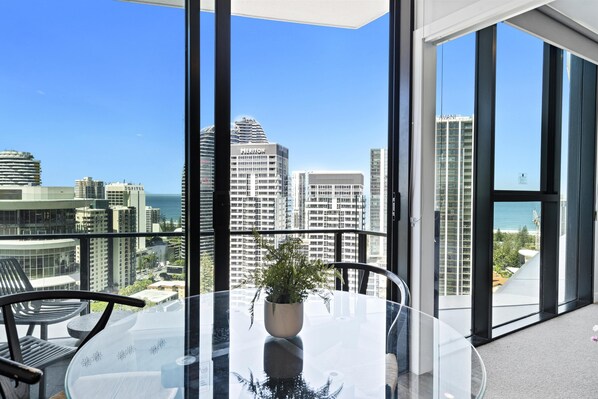 Cozy dining area overlooking the city with the ocean as the backdrop