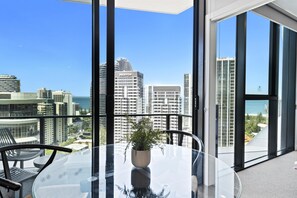 Cozy dining area overlooking the city with the ocean as the backdrop