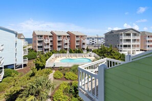 View from balcony overlooking pool and ocean