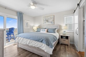 Master bedroom with king bed and smart TV.