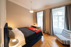 Bedroom with large double bed 180 x 200 cm and folding single bed 90 x 200 cm. Work desk and wardrobe.