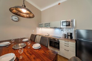 Living room with Smart TV, large dining table, folding sofa bed and fully equipped kitchen