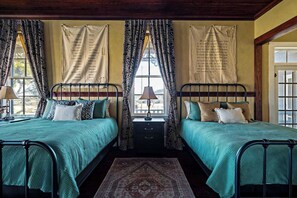 This spacious bedroom features two comfortable queen-sized beds, perfect for families or groups traveling together.