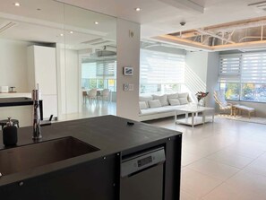 View of the living room from the kitchen.  High-quality shades for whole house.  You can close the blinds for privacy.  Living room with open kitchen lay out,