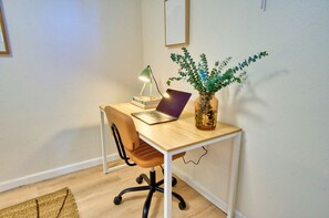 Quiet workspace with a desk and chair, ideal for productivity during your stay.