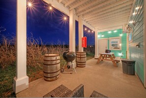Lower-level patio with a grill and picnic table.