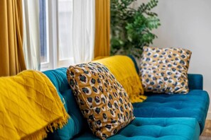 Snuggle up on our comfy electric blue couch and enjoy the Smart TV apps or live cable through YouTube TV