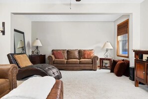 Comfortable main living room with oversized seating, perfect for relaxing after a day of exploring.