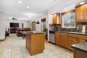 Bright and open kitchen with island seating flows easily into the living and dining spaces.
