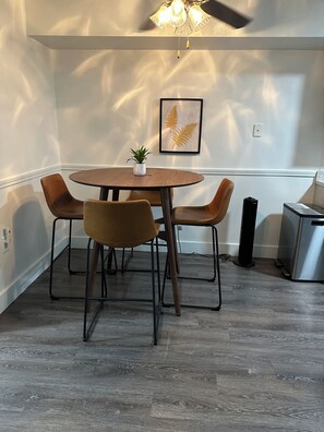 Dining room with high-top table and chairs.