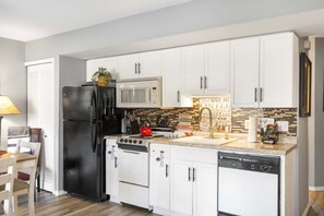 The open kitchen offers ample storage & every home comfort