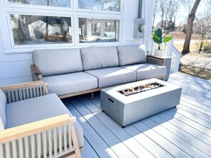 Spacious & inviting lounge area with seating, fire pit table & new Weber grill.