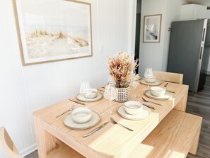 Light-filled dining room comfortably seats 6. Connects to back deck.