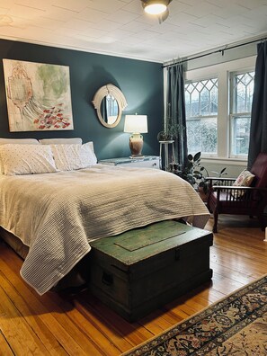 Organic Queen mattress and four sunny windows make this Bedroom unforgettable.