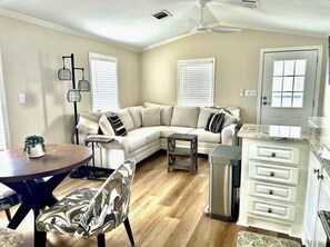Relax in the inviting living room with a plush L-shaped sofa and a smart TV 