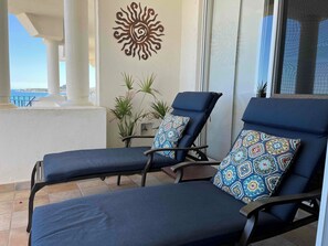 Large deck area has chaise lounges, deck chairs, patio dining and weber grill 