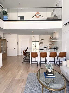 Open concept kitchen, living room and loft area above