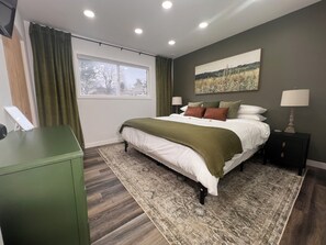 King bed, buttery soft linens, black out blinds, desk/vanity, full length mirror