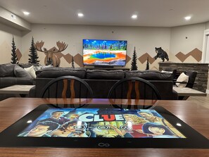 Get ready to play in our basement family room, where an Infinity Game Table awaits your next gaming adventure. With limitless possibilities, let the games begin!