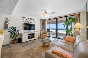 Bright and comfortable living space with large windows and stylish decor.