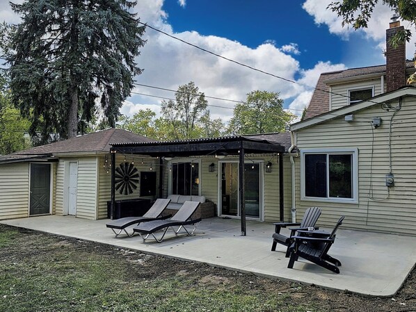 Enjoy a private fenced backyard with a BBQ grill and cozy seating
