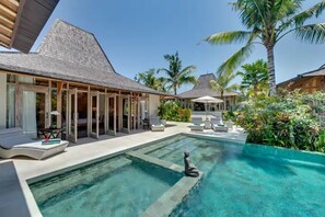 Pool, sunbeds and view of the master and main joglo across the garden.