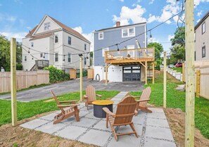 Enjoy cozy evenings by the fire pit in the backyard