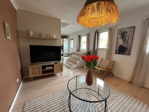 living room, sofa, air conditioning, coffee table, chairs, miror, TV, terrace (1)