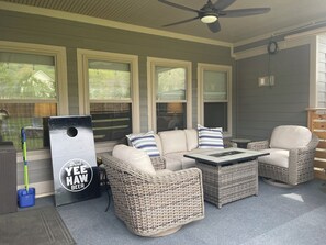 Backyard patio has a gas fire pit, a gas grill, and very comfortable furniture.